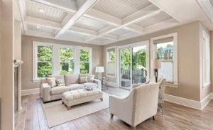 Bright living room with large windows and cozy furniture. Room addition by Tampa top home remodelers for 20 years: CMK Construction