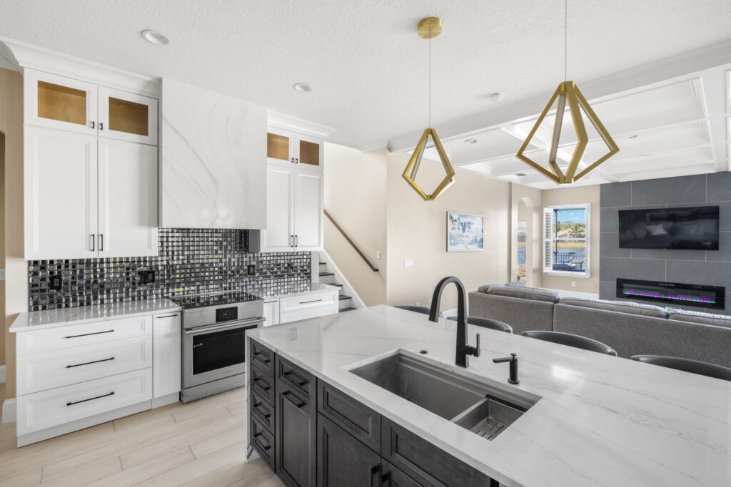 Modern kitchen with island and stainless steel appliances.