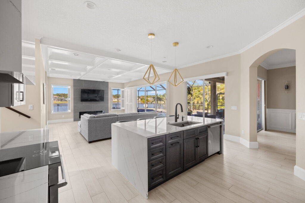 Modern kitchen and living room with water view.