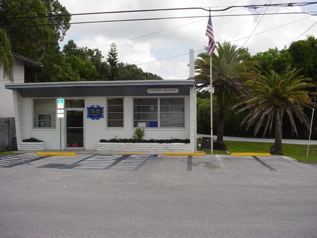 Crystal Beach community center with palm trees.