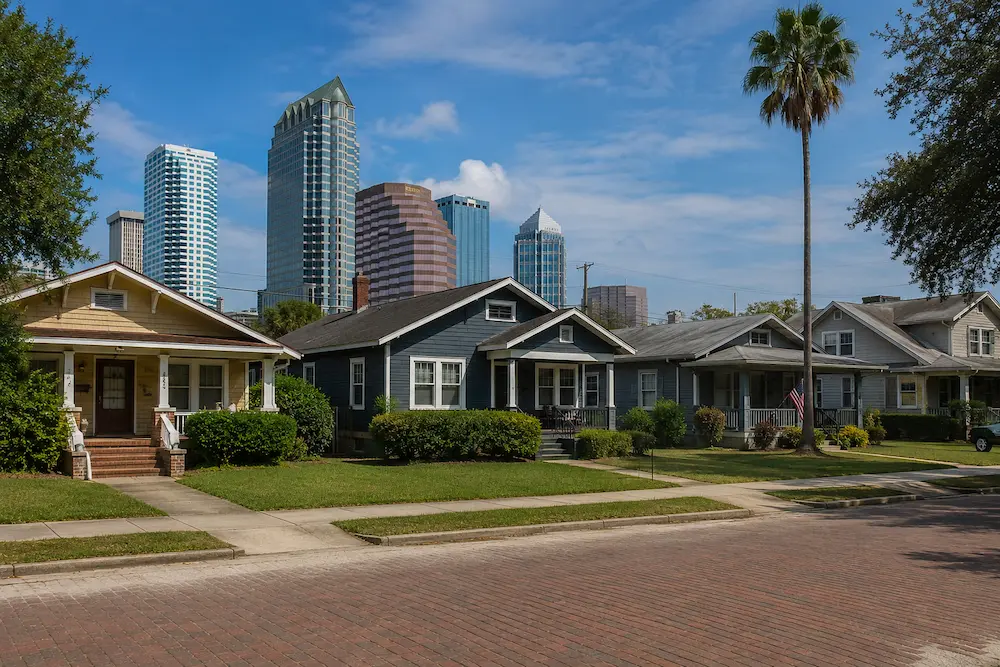 Tampa neighborhood street with historic bungalows and the downtown skyline behind, the range of homes CMK Construction remodels across the city