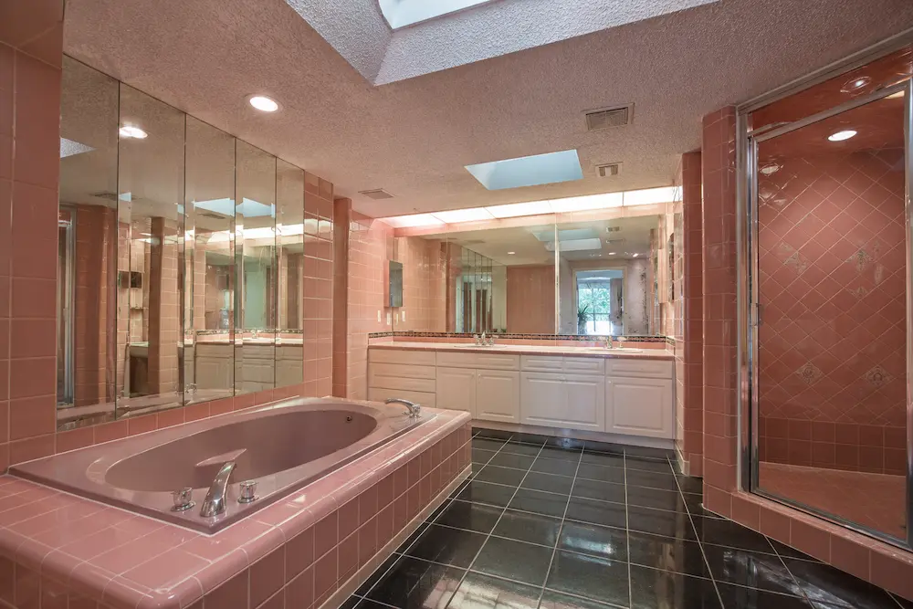Original 1927 bathroom in a Seminole Heights bungalow with galvanized plumbing and original cast-iron tub before CMK Construction renovation